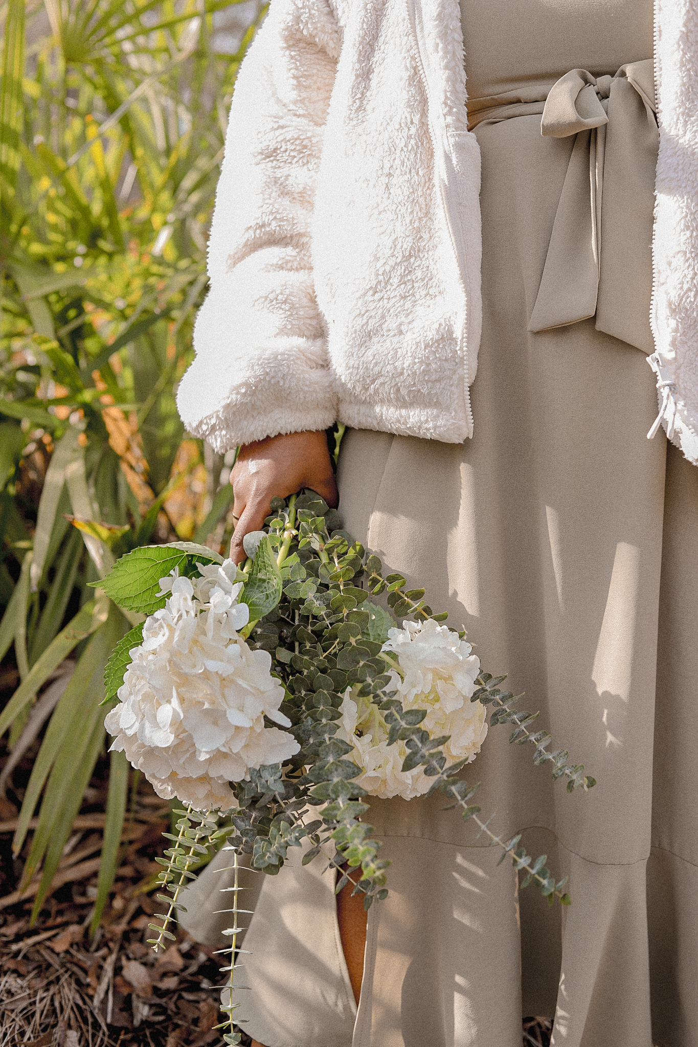 girl in white coat holding white flowers with Tips for Marketing Online